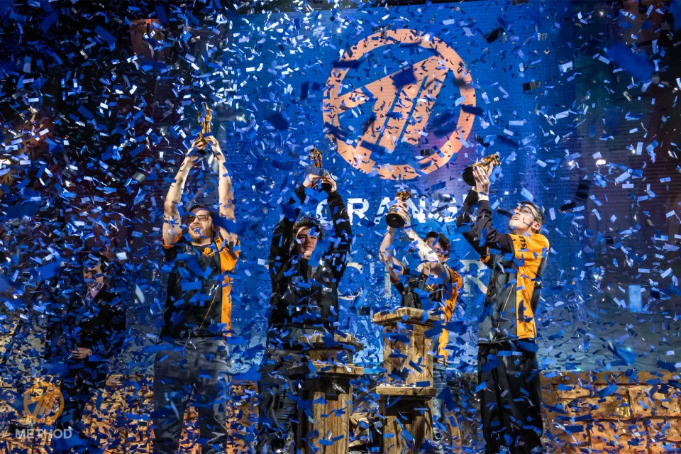 Method team in jerseys celebrating with trophies